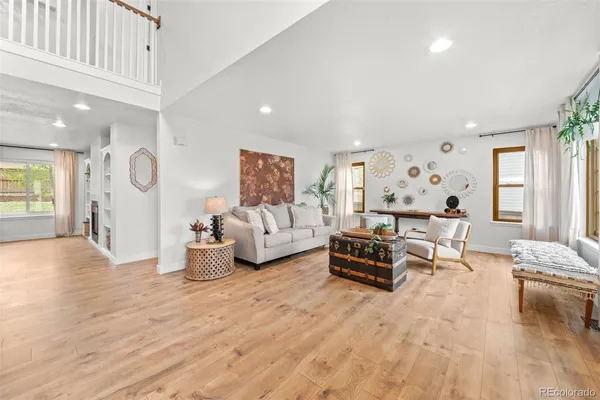 a living room with furniture and wooden floor