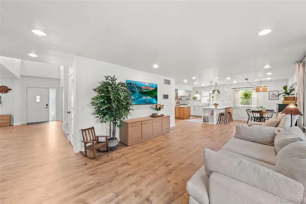a living room with furniture and a kitchen view