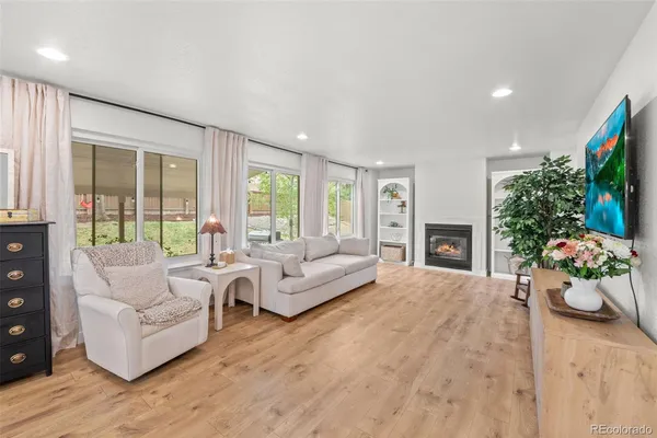 a living room with furniture potted plant and a fireplace
