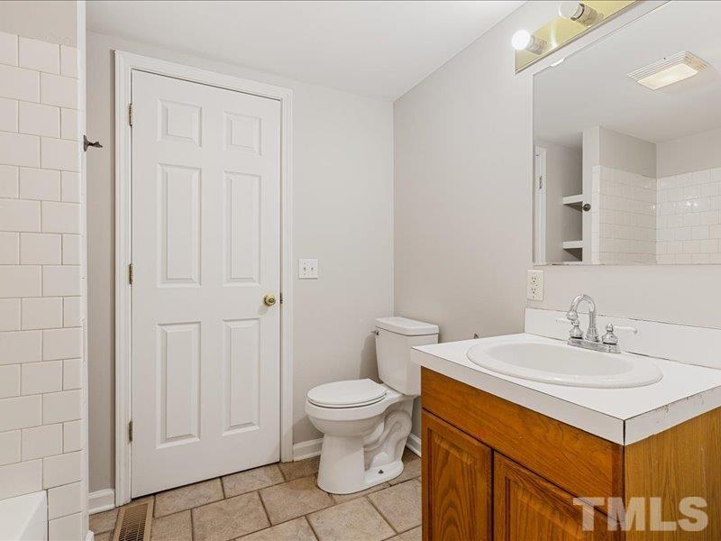 4010 Hurst Drive Franklinton, NC 27525 - Photo 17 of 32 a bathroom with a sink a toilet and a mirror