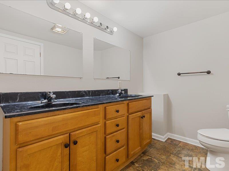 4010 Hurst Drive Franklinton, NC 27525 - Photo 27 of 32 a bathroom with a granite countertop sink and a toilet