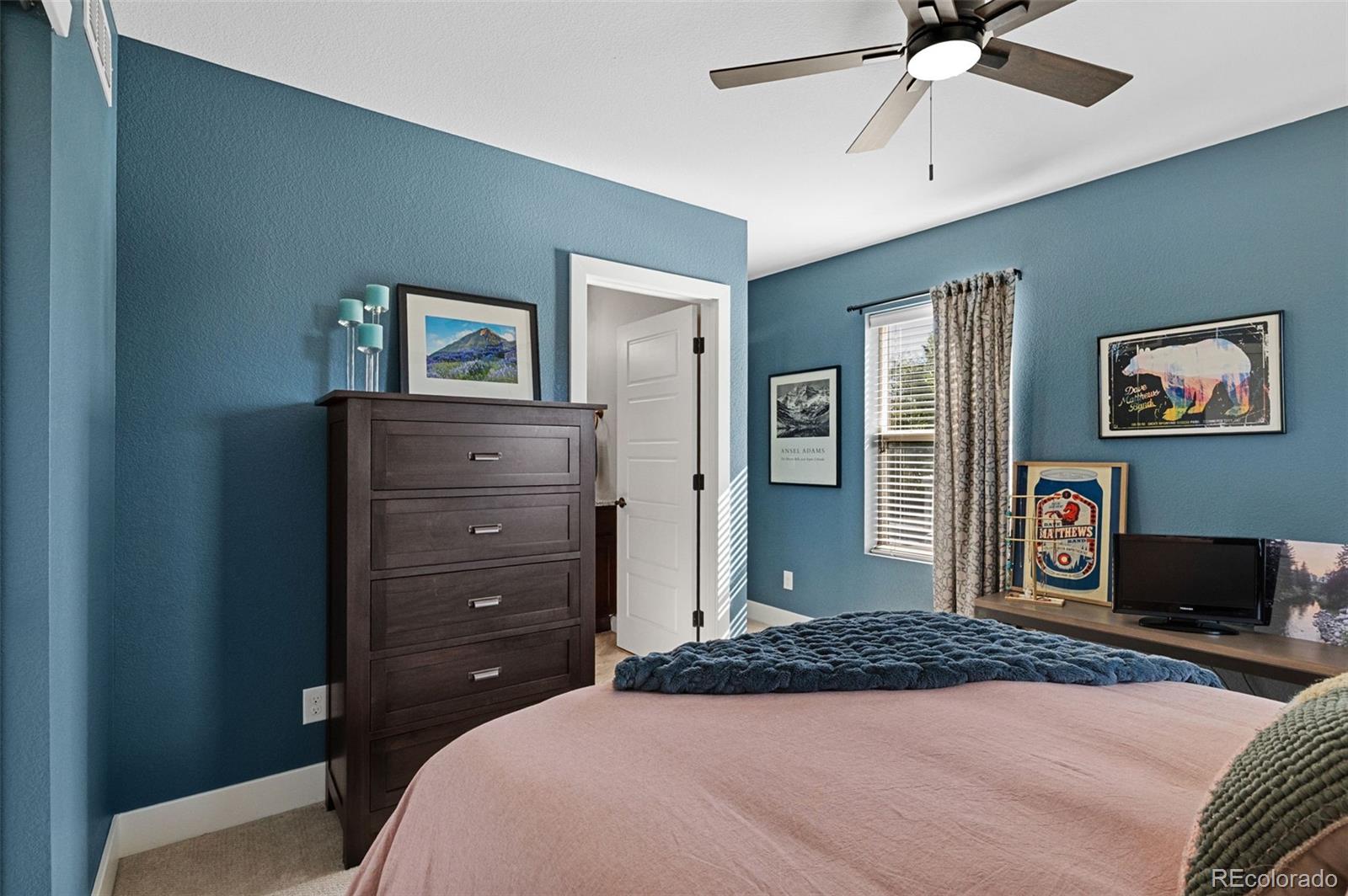 1583 South Ogden Street, Unit 1583 Denver, CO 80210 - Photo 16 of 28 a bedroom with a bed and a chandelier