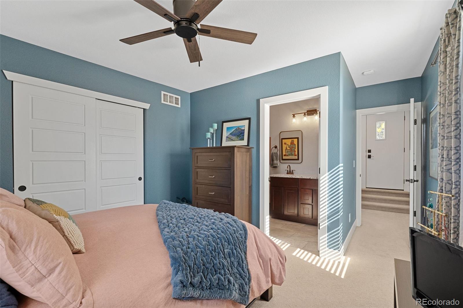 1583 South Ogden Street, Unit 1583 Denver, CO 80210 - Photo 17 of 28 a bedroom with a bed and a chandelier