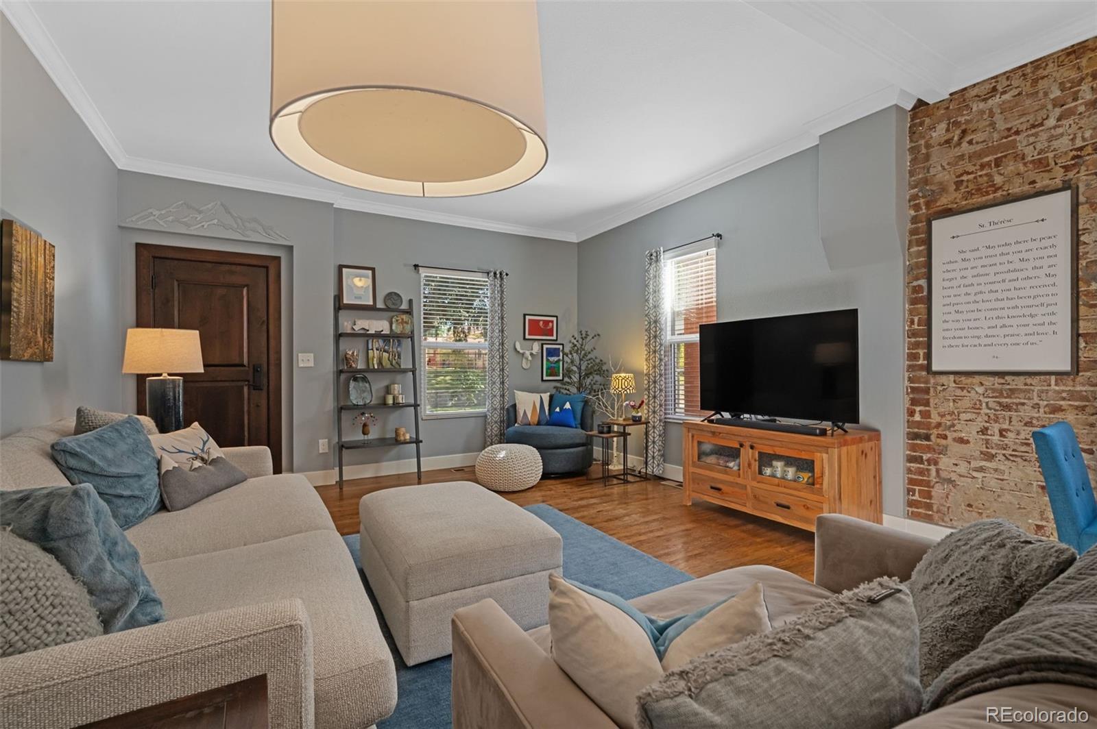 1583 South Ogden Street, Unit 1583 Denver, CO 80210 - Photo 2 of 28 a living room with furniture and a flat screen tv
