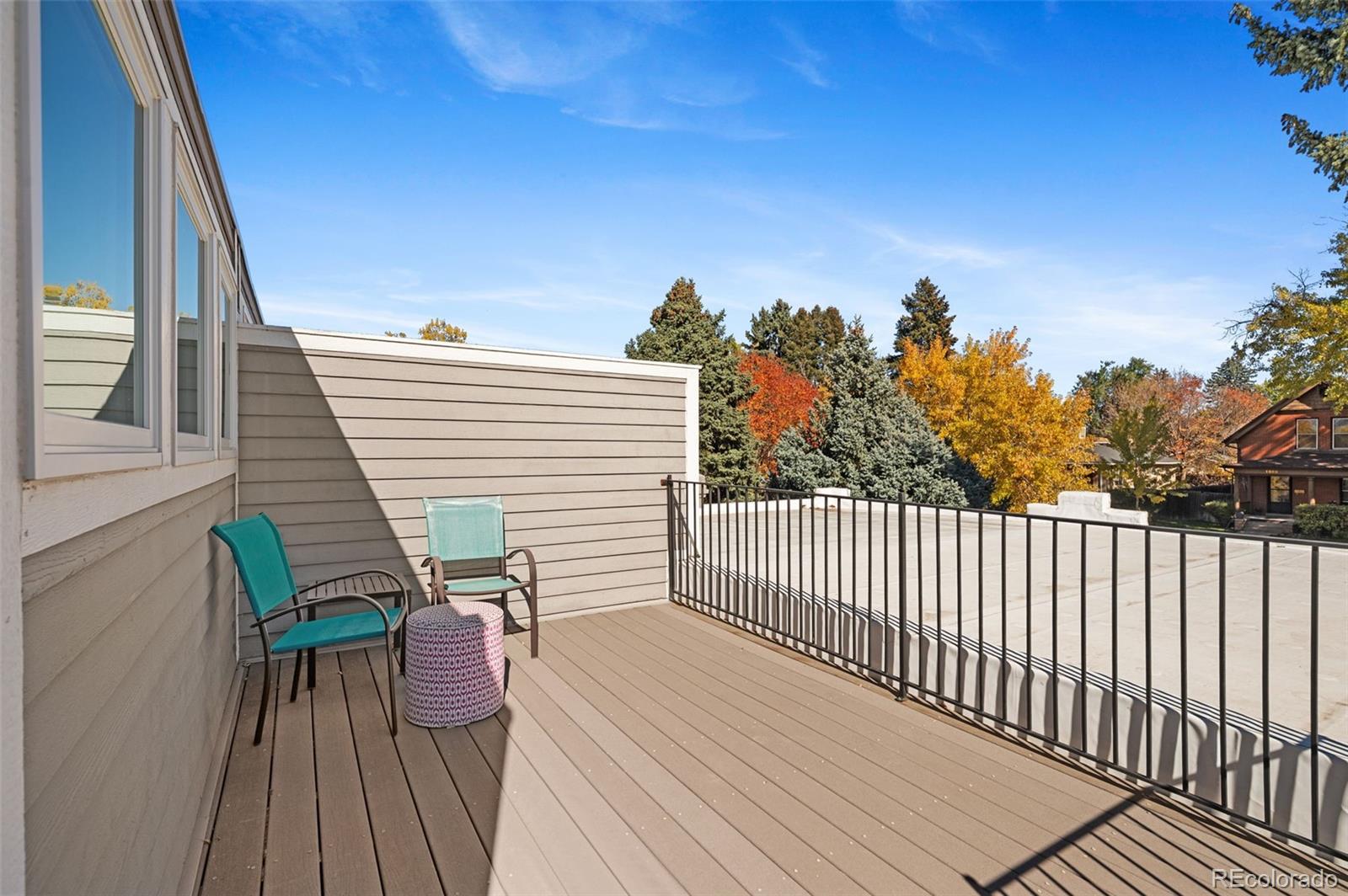 1583 South Ogden Street, Unit 1583 Denver, CO 80210 - Photo 22 of 28 a view of a roof deck with wooden floor and fence