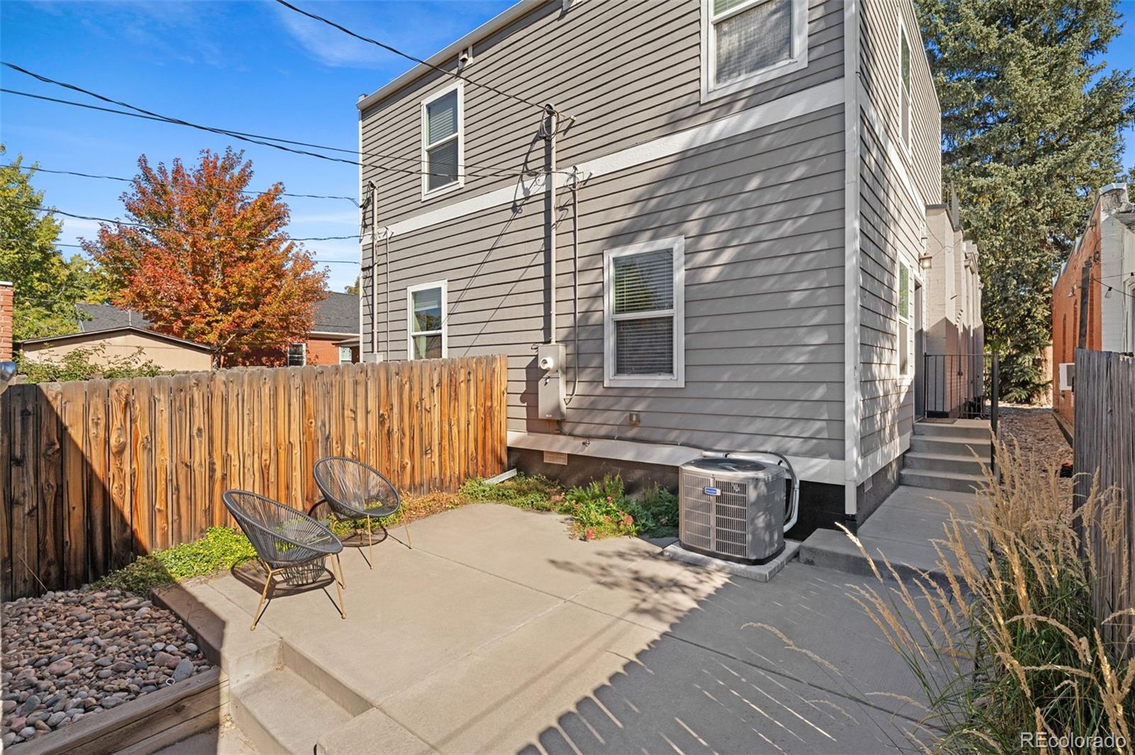 1583 South Ogden Street, Unit 1583 Denver, CO 80210 - Photo 25 of 28 a view of a backyard with a chair and table in the patio
