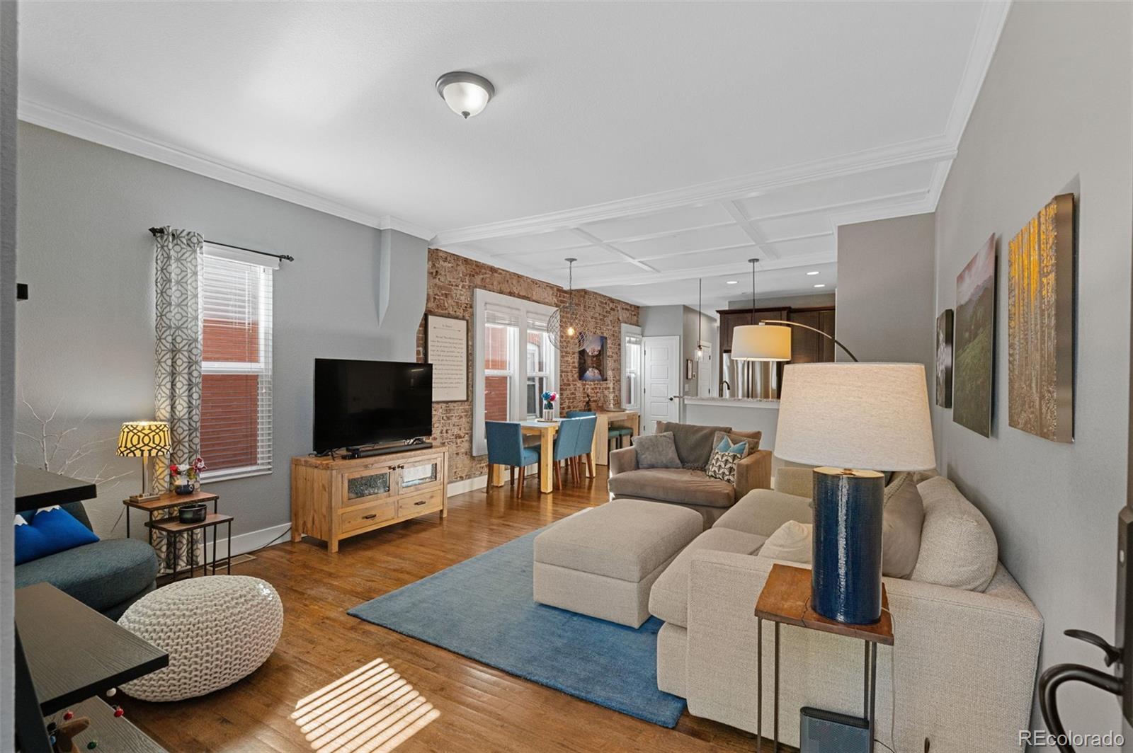 1583 South Ogden Street, Unit 1583 Denver, CO 80210 - Photo 4 of 28 a living room with furniture and a flat screen tv