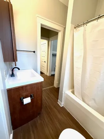 a bathroom with a sink a mirror and a shower