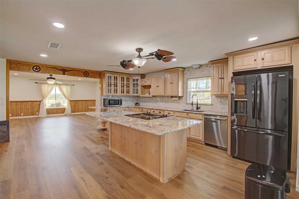 3559 Springfield Road Springtown, TX 76082 - Photo 6 of 37 a kitchen with a stove a refrigerator and a fireplace
