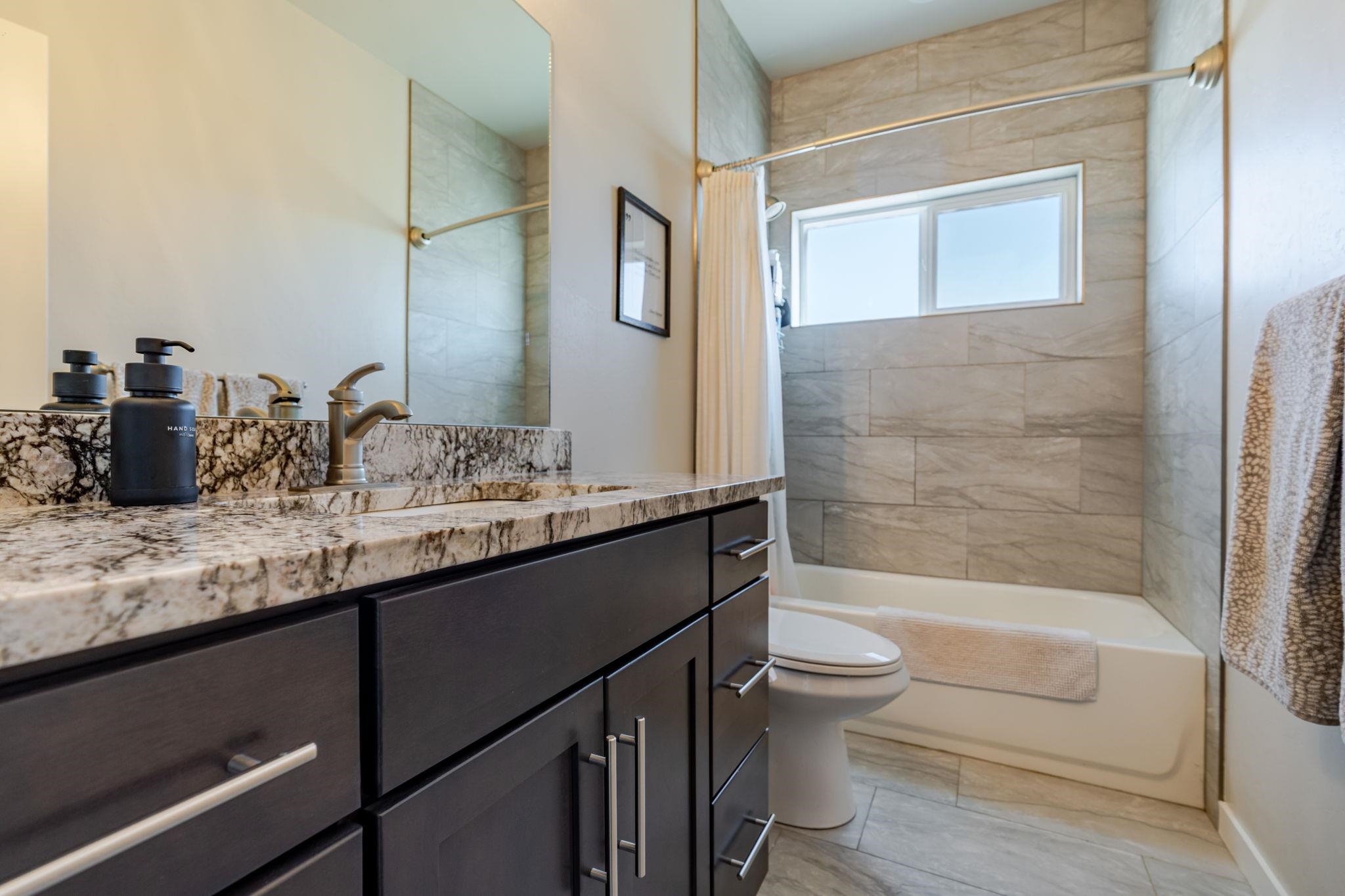 1301 M Road Loma, CO 81524 - Photo 24 of 32 a bathroom with a granite countertop sink toilet and shower