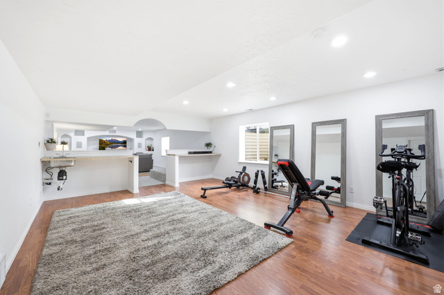 1816 River Bottom Road Springville, UT 84663 - Photo 19 of 37 Spacious lower-level room featuring wood-finish flooring, recessed lighting, a built-in wet bar with sink, and a window providing natural light