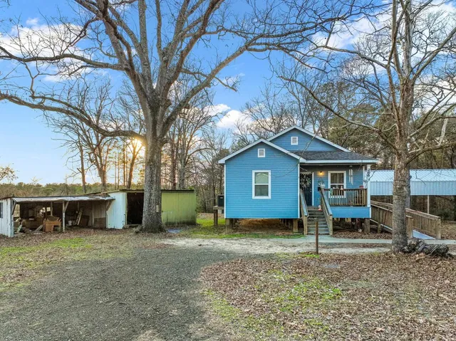 a house that has a tree in front of it