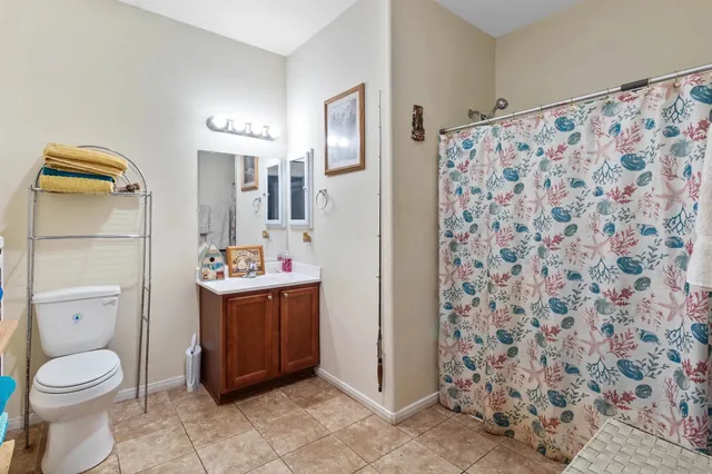 a spacious bathroom with a granite countertop sink a toilet and shower