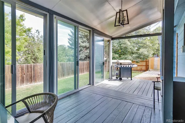a room with balcony wooden floor and furniture