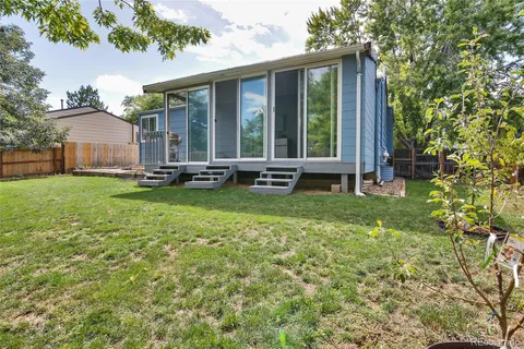 a view of a house with a yard and sitting area
