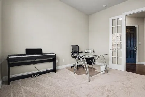 a view of a workspace with furniture and a window