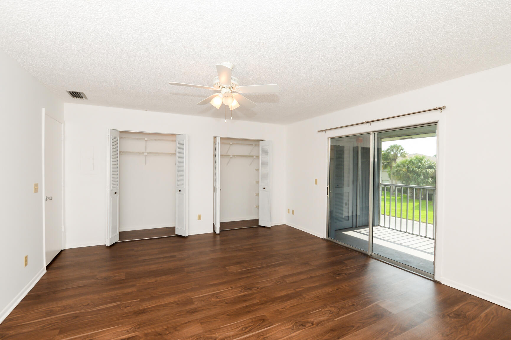 8 Lake Vista Trail, Unit 205 Port St. Lucie, FL 34952 - Photo 11 of 24 an empty room with wooden floor and windows