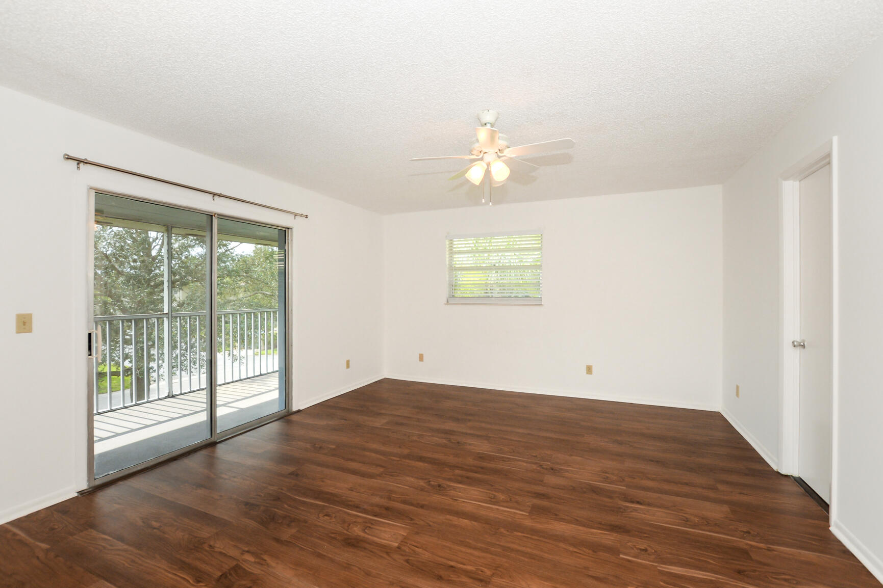 8 Lake Vista Trail, Unit 205 Port St. Lucie, FL 34952 - Photo 12 of 24 an empty room with wooden floor and windows