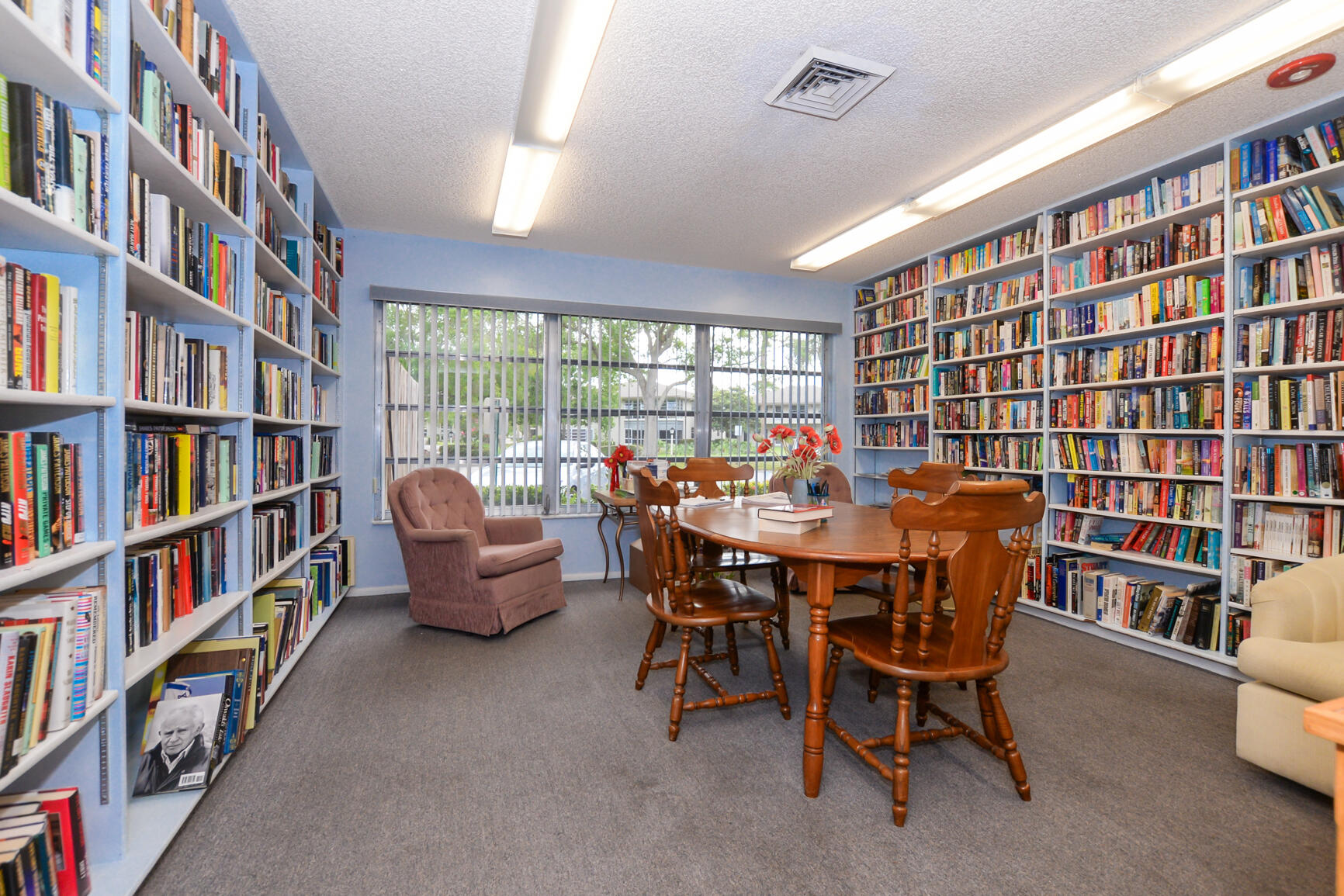 8 Lake Vista Trail, Unit 205 Port St. Lucie, FL 34952 - Photo 20 of 24 a dining room with a furniture and a book shelf