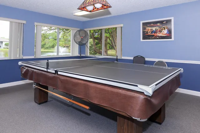 a bed sitting in a room with a large window