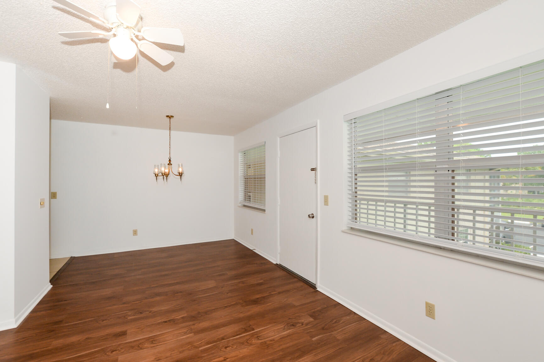 8 Lake Vista Trail, Unit 205 Port St. Lucie, FL 34952 - Photo 5 of 24 a view of empty room with wooden floor and fan