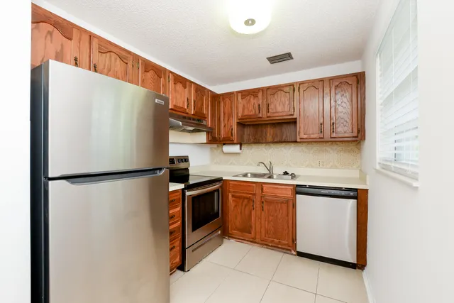 a white refrigerator freezer sitting inside of a kitchen