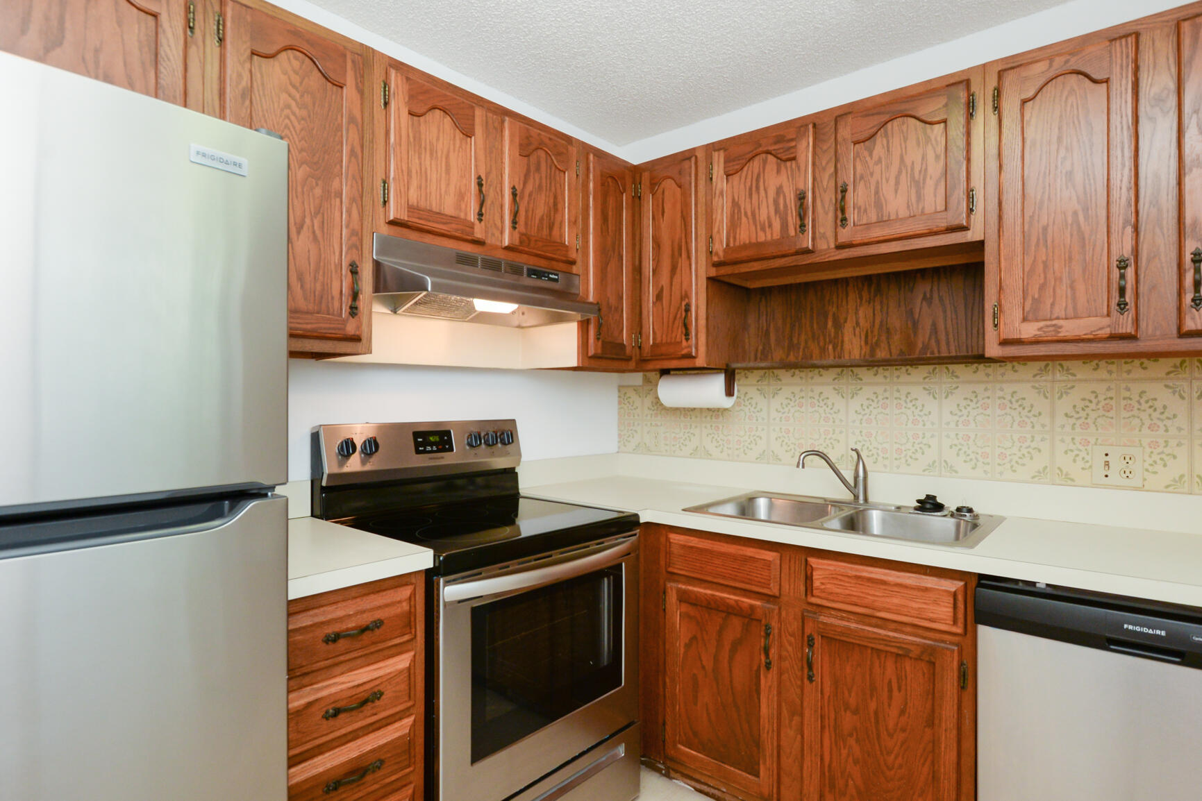 8 Lake Vista Trail, Unit 205 Port St. Lucie, FL 34952 - Photo 7 of 24 a kitchen with stainless steel appliances granite countertop a refrigerator stove a sink and dishwasher