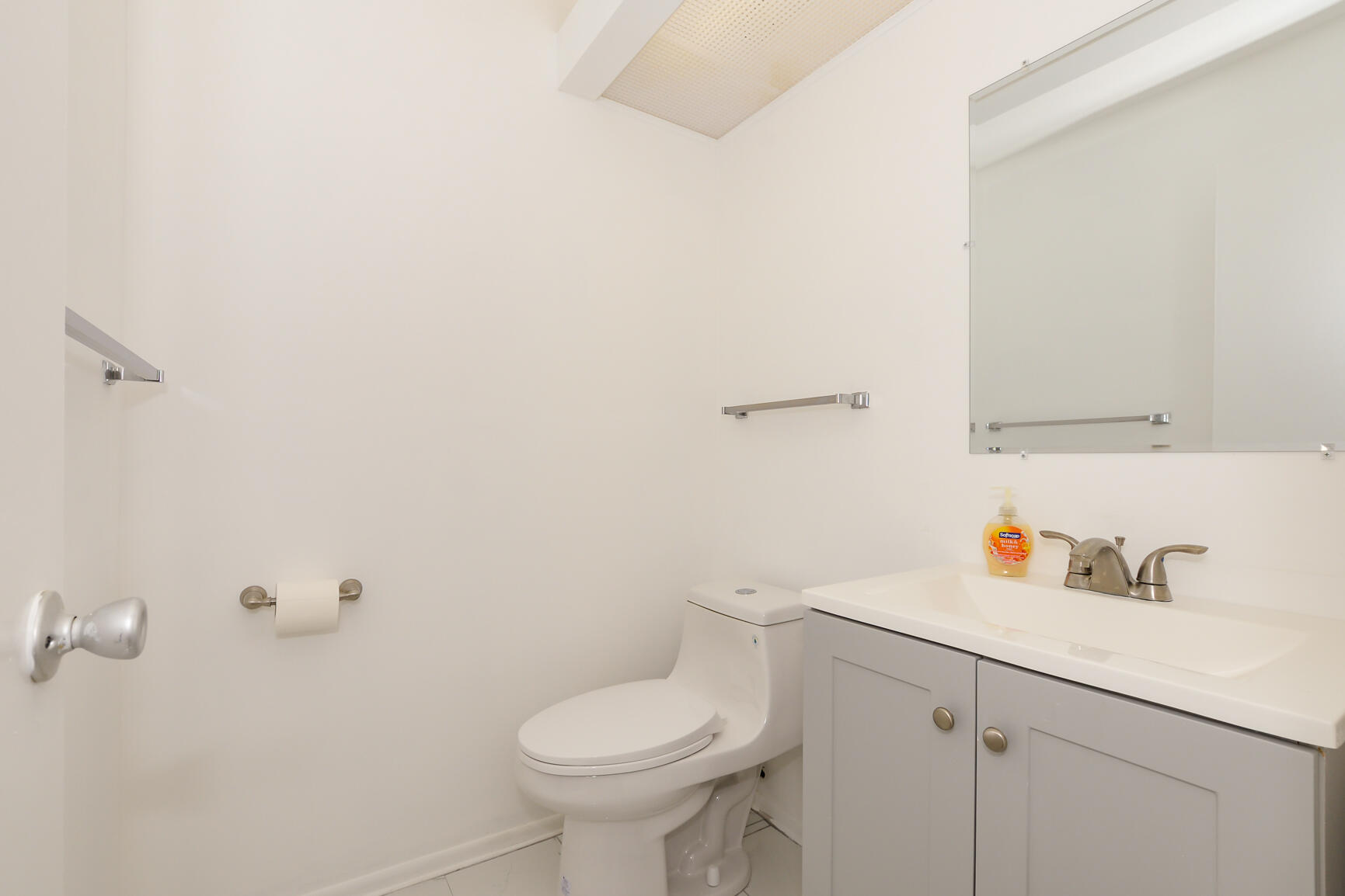 8 Lake Vista Trail, Unit 205 Port St. Lucie, FL 34952 - Photo 9 of 24 a bathroom with a sink toilet and vanity