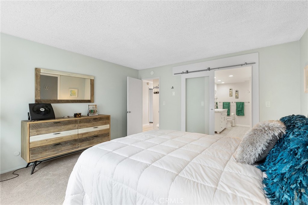 3606 Vista Rey, Unit 31 Oceanside, CA 92057 - Photo 18 of 50 Primary bedroom with sliding barn door