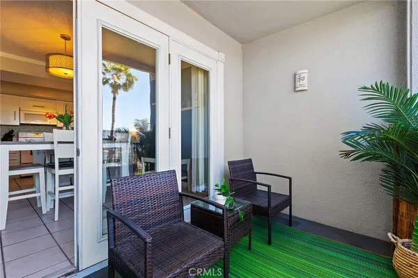 a balcony with furniture and wooden floor