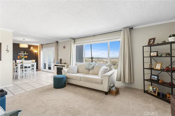 a living room with furniture a dining table and a flat screen tv