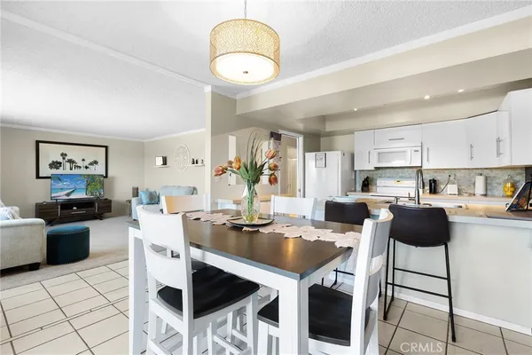 a kitchen with stainless steel appliances kitchen island granite countertop a table and chairs in it
