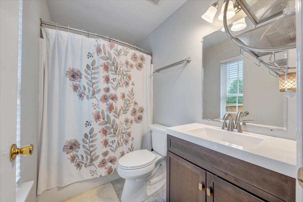 4751 Westvale Road Northeast Roanoke, VA 24019 - Photo 15 of 30 a bathroom with a sink a toilet and a mirror