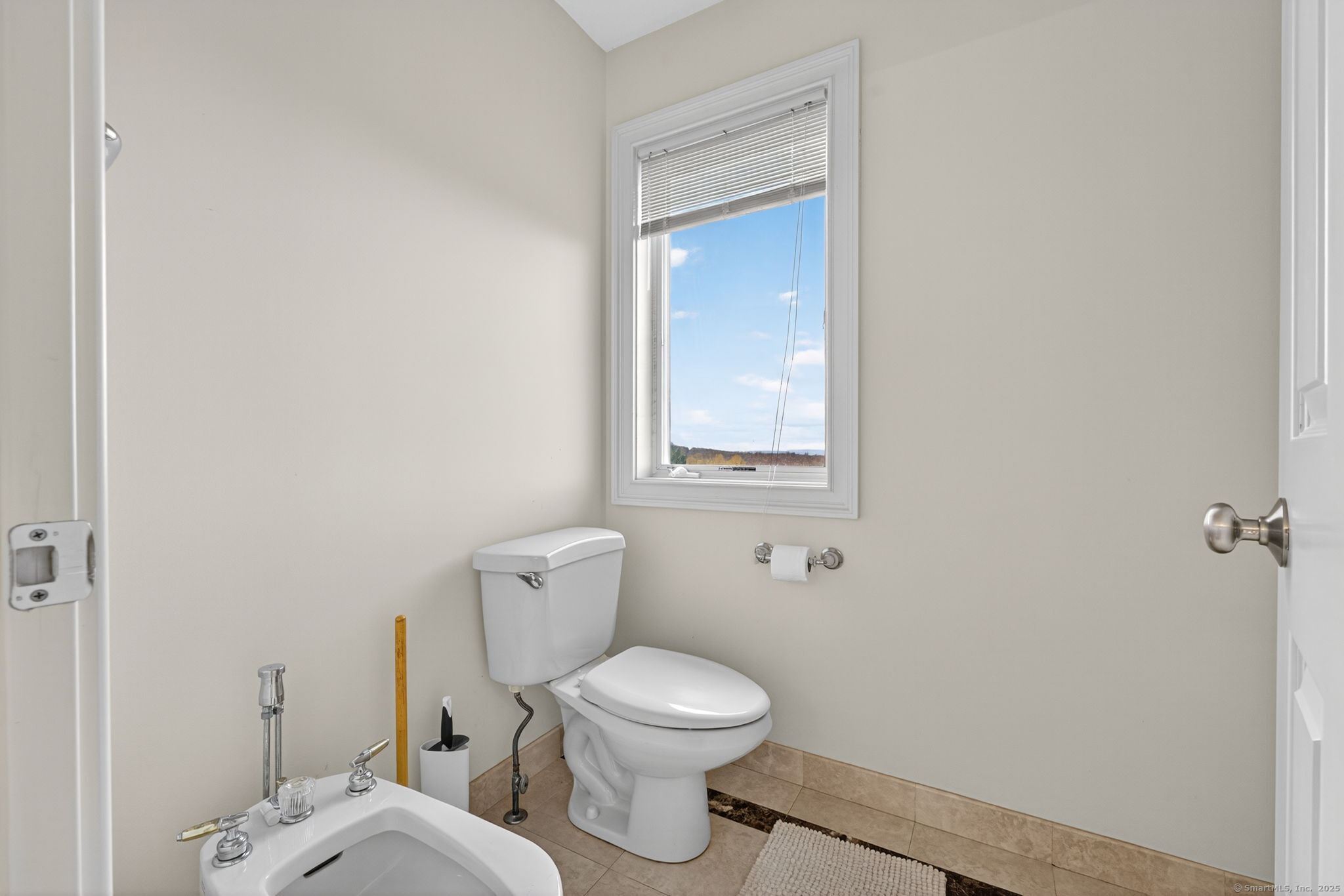 87 Colton Road Glastonbury, CT 06033 - Photo 22 of 39 a white toilet sitting next to a bathroom sink and vanity