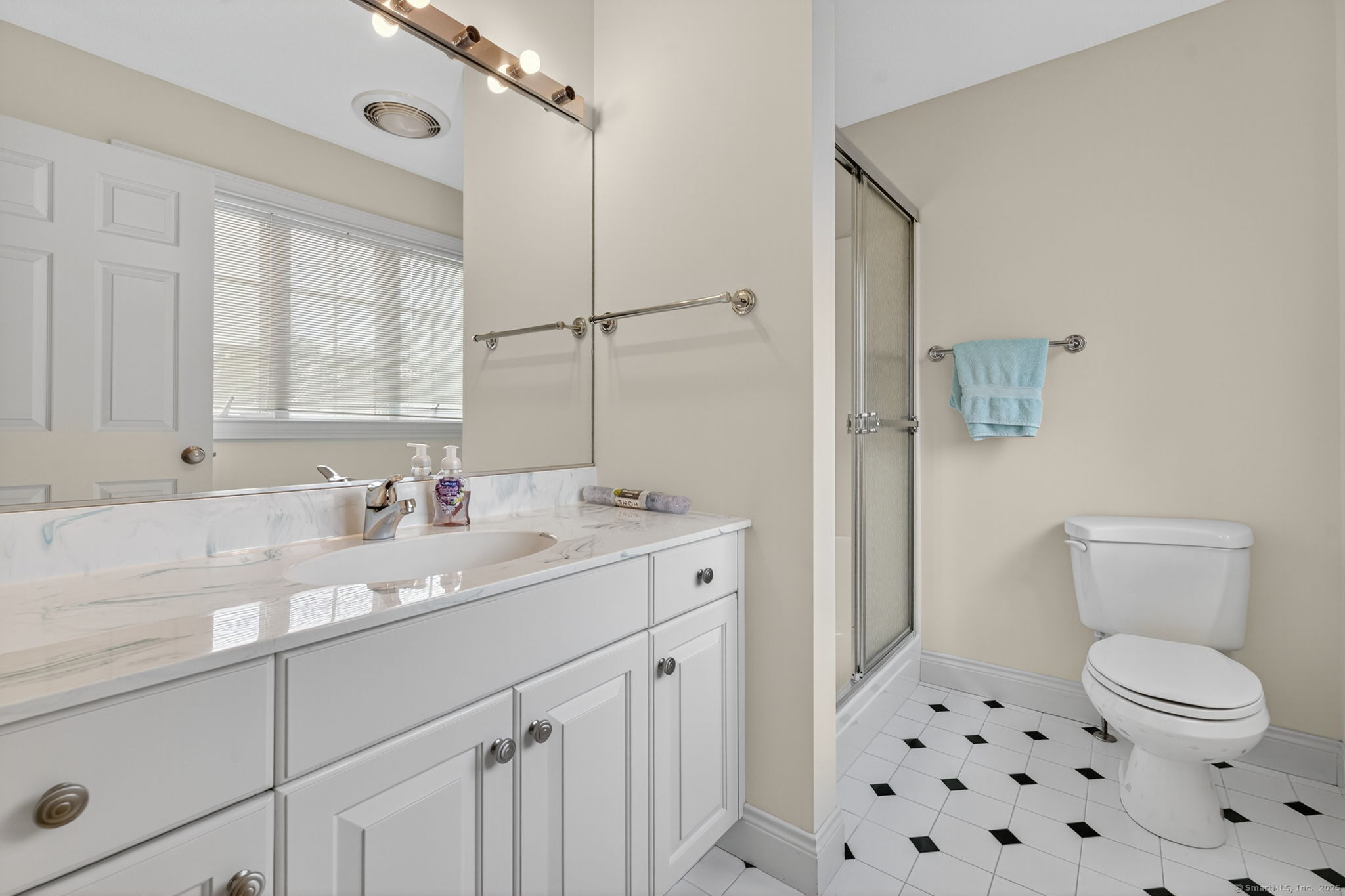87 Colton Road Glastonbury, CT 06033 - Photo 25 of 39 a bathroom with a sink a toilet and a large mirror