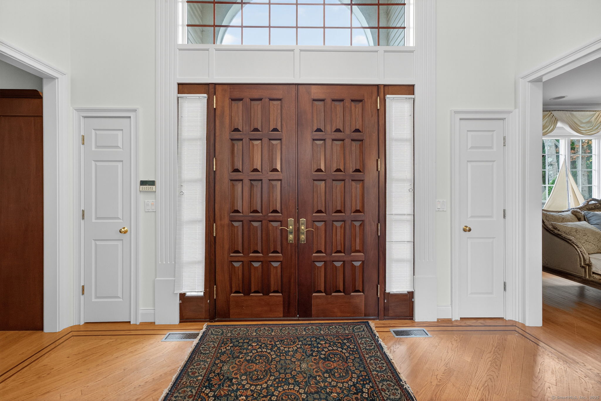 87 Colton Road Glastonbury, CT 06033 - Photo 4 of 39 a view of a hallway with wooden floor and a livingroom