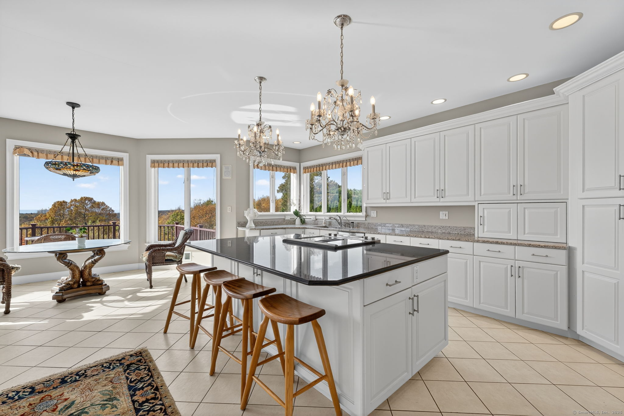 87 Colton Road Glastonbury, CT 06033 - Photo 7 of 39 a kitchen with stainless steel appliances granite countertop a stove a sink dishwasher a dining table and chairs with wooden floor