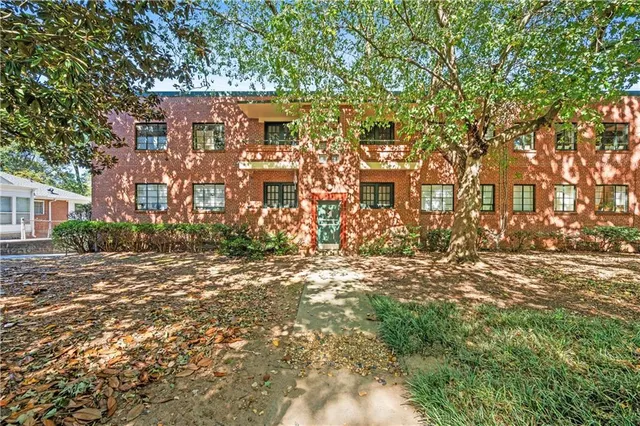 a view of a large building with a tree