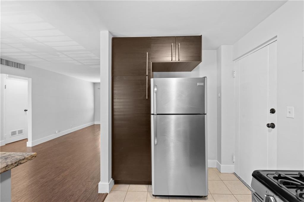 1370 Chalmette Drive Northeast, Unit 2 Atlanta, GA 30306 - Photo 12 of 16 a metallic refrigerator freezer sitting in a kitchen