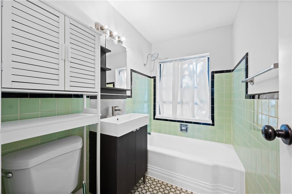 1370 Chalmette Drive Northeast, Unit 2 Atlanta, GA 30306 - Photo 14 of 16 a bathroom with a sink and a bathtub