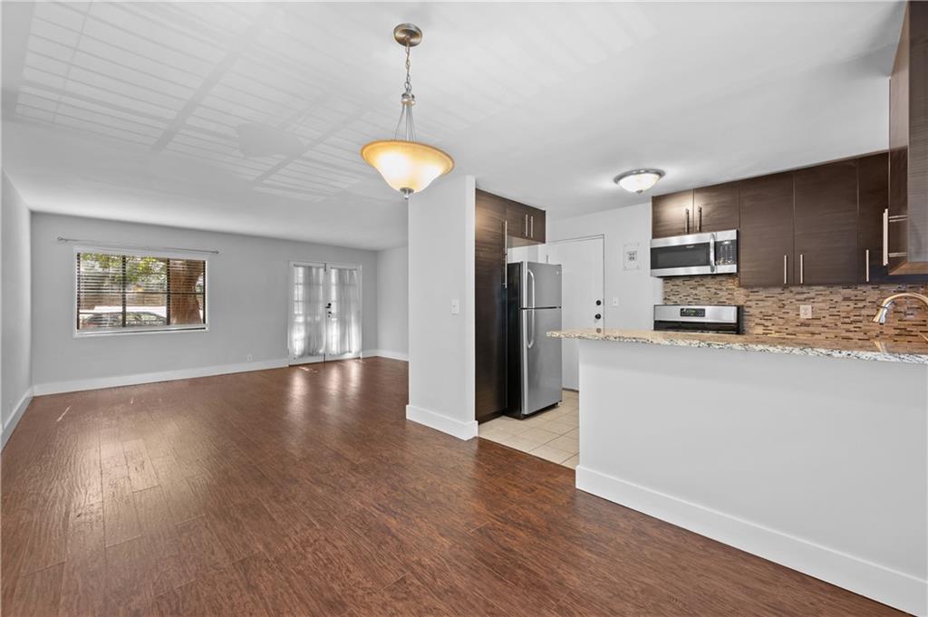 1370 Chalmette Drive Northeast, Unit 2 Atlanta, GA 30306 - Photo 3 of 16 a view of a kitchen center island wooden floor and a refrigerator