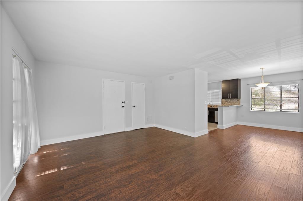 1370 Chalmette Drive Northeast, Unit 2 Atlanta, GA 30306 - Photo 6 of 16 an empty room with wooden floor and windows