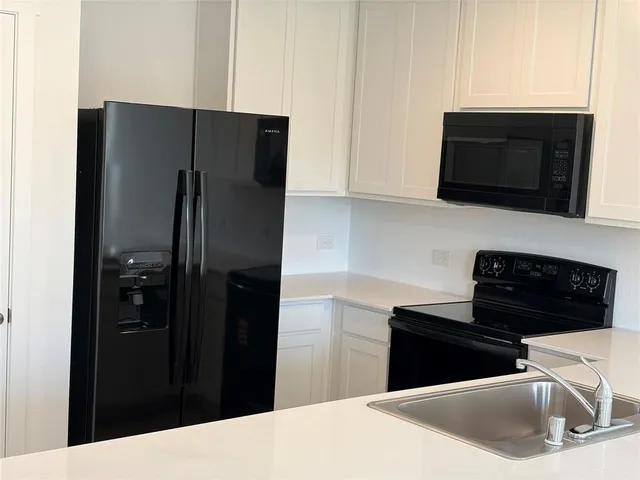 a kitchen with a refrigerator stove and microwave