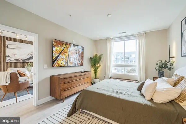 a bedroom with a bed and a large window
