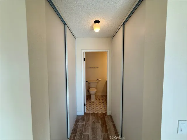 a bathroom with a toilet a sink a mirror and vanity