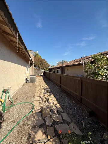 a view of a chair and table in the backyard
