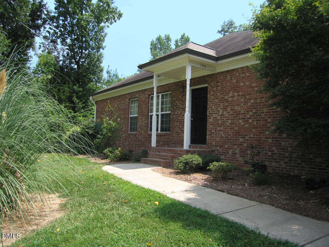 101 Rock Haven Road, Unit A100 Carrboro, NC 27510 - Photo 1 of 16 a front view of a house with garden