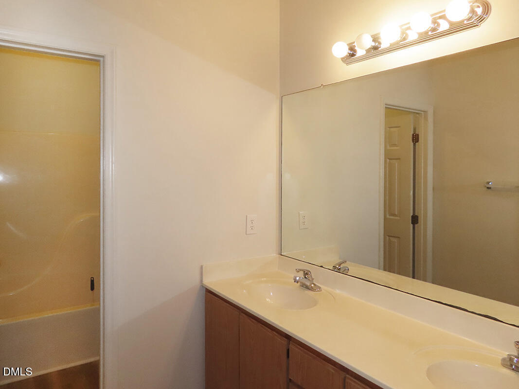 101 Rock Haven Road, Unit A100 Carrboro, NC 27510 - Photo 11 of 16 a bathroom with a sink and a mirror