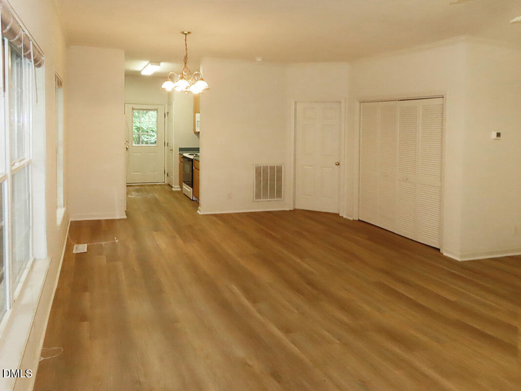 101 Rock Haven Road, Unit A100 Carrboro, NC 27510 - Photo 2 of 16 a view of a big room with wooden floor and a bathroom