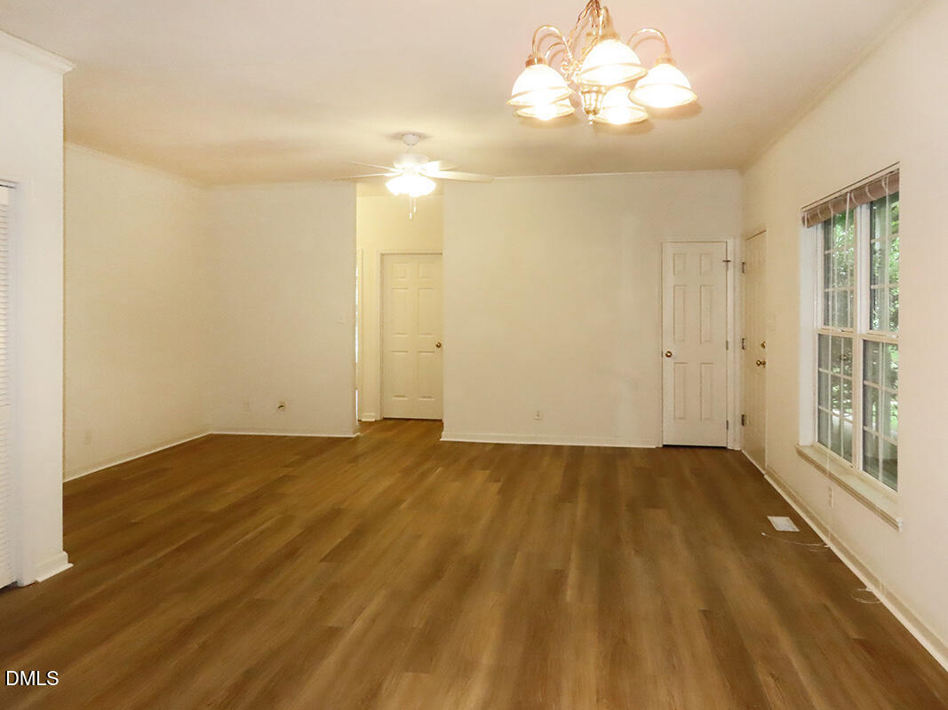 101 Rock Haven Road, Unit A100 Carrboro, NC 27510 - Photo 4 of 16 wooden floor in an empty room with a window